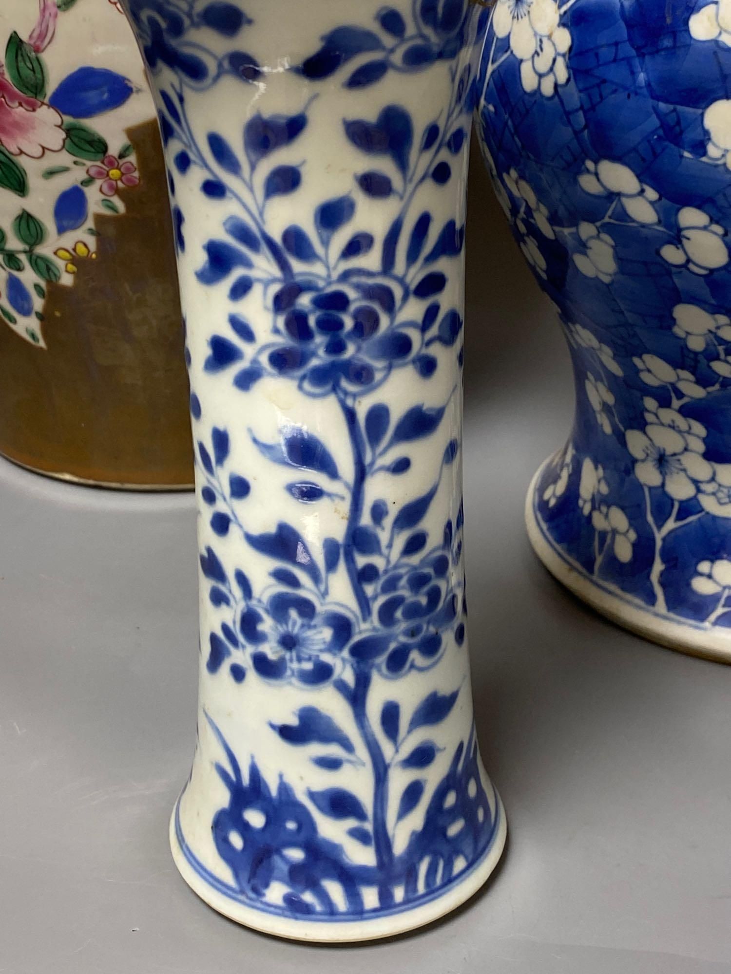 Two Chinese Kangxi period blue and white vases and a Qianlong Batavia vase and cover, largest 36cm high including the cover